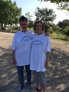 Madeline and La Nelle wearing T-shirts thatread Tom's Ranch Hands